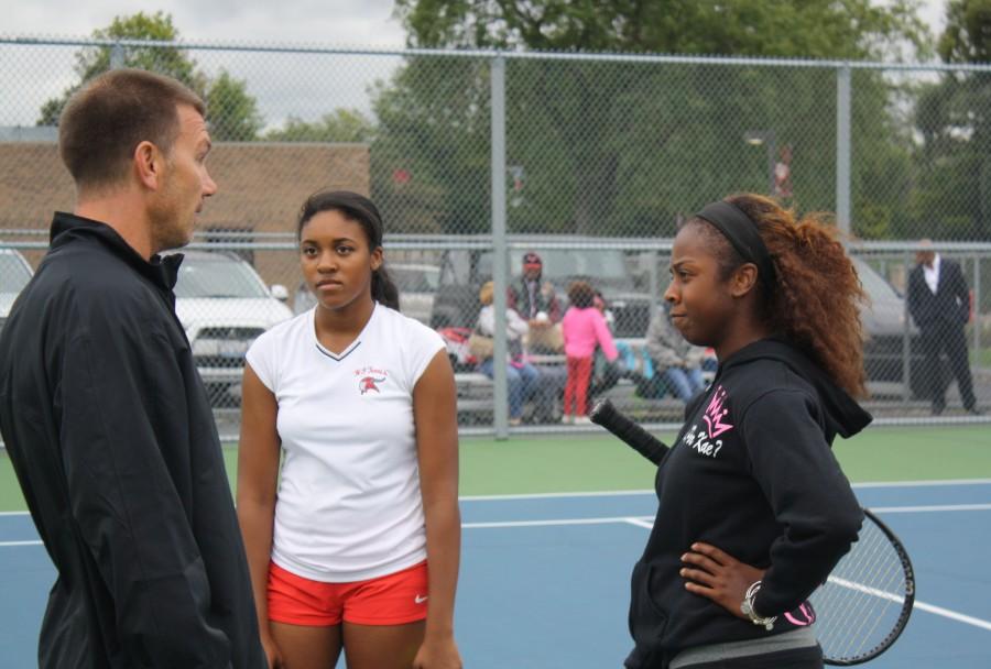 Ace Advice-  Sophomore Lauren Parker (left) and senior Kaela Mack receive advice from coach Don Baron. The team hosted Andrew for Senior Night on Tuesday and won 7-0. 