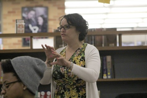 English Sahar Mustafah listens in as two students share snippets of their self written books in the library. Mustafah won the Willow Brooks Grand Prize, which comes with a publishing contract for her collection of short stories, New And Gently Used Hijab, and $1,000.  