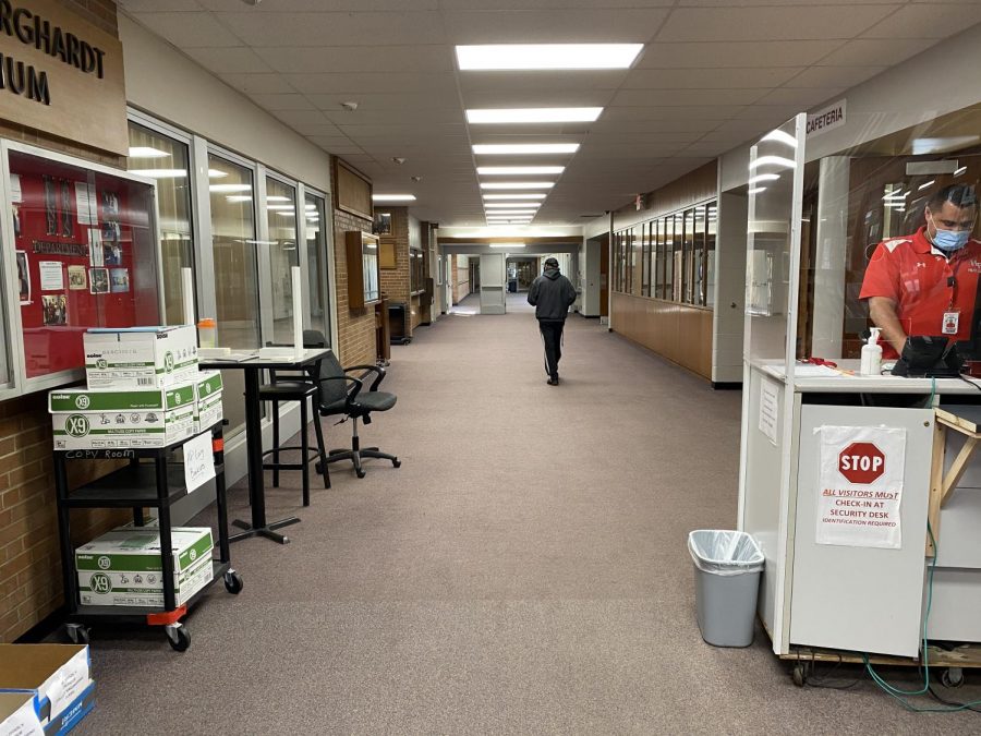 A Day at H-F.  A student heads towards the textbook center as H-F security guards check for student temperatures and self-certification forms from staff. As remote learning is in full swing at H-F, very few people are in the building on an average school day.
