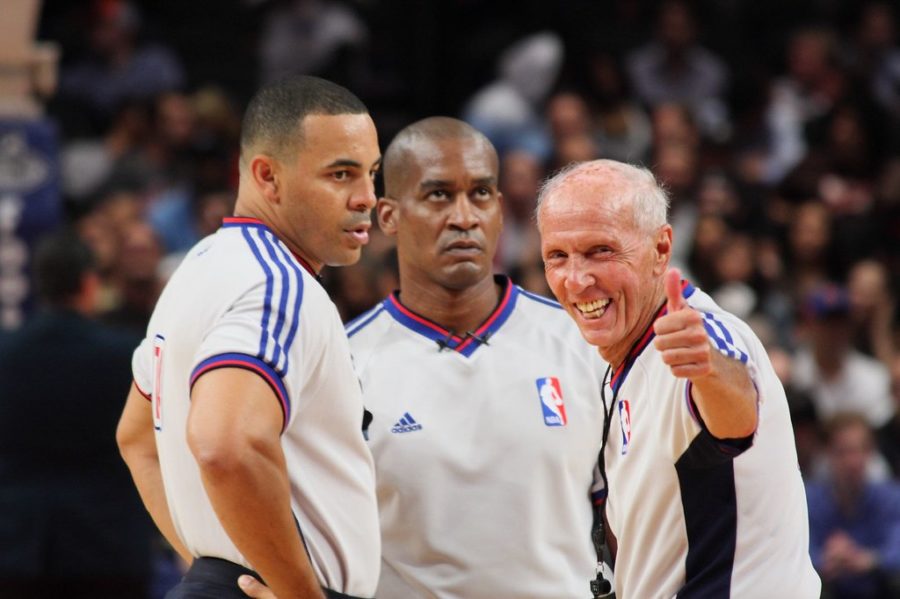 Three referees officiating at Madison Square Garden.