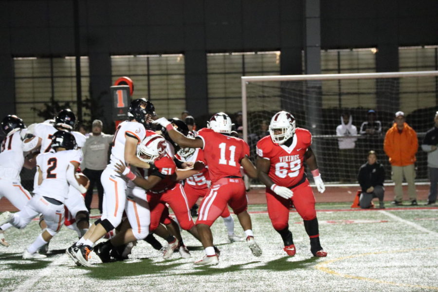 Senior Kenneth Wallace (69) rushing the passer on Senior Night against Lincoln-Way West on Oct. 22.