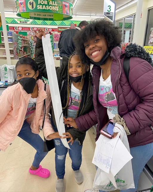 (From left to right) Sophia, Madyson, and Xiiyaire showing their receipt  of necessities from Dollar Tree