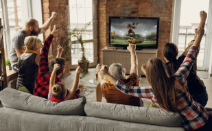 A family watching a sports game all together. 