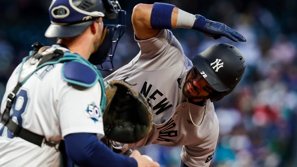 New York Yankees' infielder José Caballero taps his helmet for a challenge after an umpire's call. 